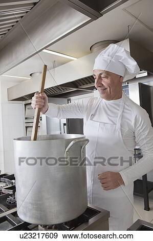Chef stirring pot View Large Photo Image Stock Photo - Chef stirring pot. Fotosearch