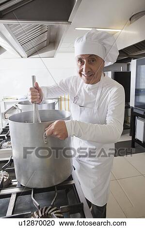 Chef using whisk in pot View Large Photo Image Stock Image - Chef using whisk in pot. Fotosearch