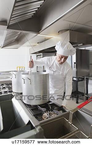 Chef using whisk in pot View Large Photo Image Stock Photo - Chef using whisk in pot. Fotosearch