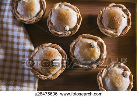 Stock Photograph - Chicken pies on wooden tray. Fotosearch