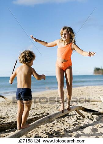 Children balancing on driftwood View Large Photo Image Picture - Children balancing on driftwood. Fotosearch