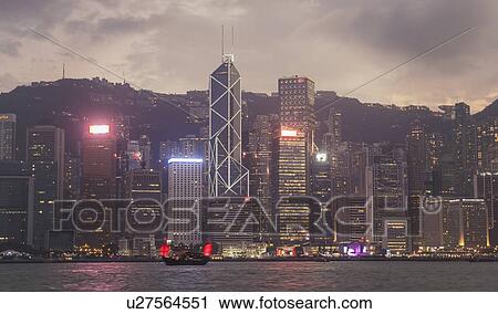 Stock Image - City skyline at sunset in Hong Kong, China. Fotosearch