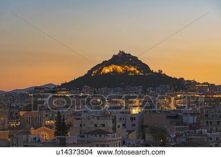Picture - Cityscape at sunrise with Mount Lycabettus in Athens, Greece. Fotosearch