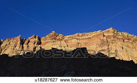 Cliff in shadow in Capitol Reef National Park, USA View Large Photo Image Stock Photo - Cliff in shadow in Capitol Reef National Park, USA. Fotosearch