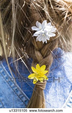 Stock Photography - Close up of flowers in girl's braided hair. Fotosearch