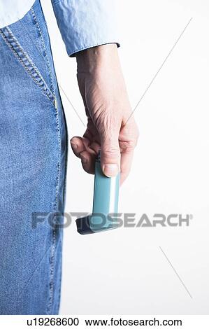 Close-up of hand holding an asthma inhaler. The inhaler contains bronchodilator drugs, which widen constricted airways in the lungs. View Large Photo Image Stock Image - Close-up of hand holding an asthma inhaler. The inhaler contains bronchodilator drugs, which widen constricted airways in the lungs.. Fotosearch