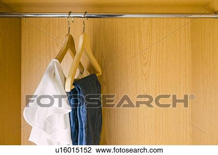 Clothes hanging in wardrobe View Large Photo Image Stock Image - Clothes hanging in wardrobe. Fotosearch