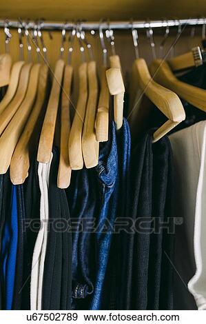 Stock Photo - Clothes in wardrobe. Fotosearch