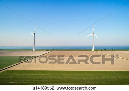 Stock Image - Coastal wind turbines and field landscape in spring, elevated view, Urk, Flevoland, Netherlands. Fotosearch