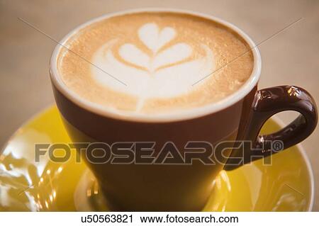 Coffee in yellow cup with heart shape View Large Photo Image Stock Image - Coffee in yellow cup with heart shape. Fotosearch