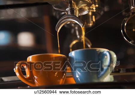 Coffee pouring from portafilter into coffee cups View Large Photo Image Picture - Coffee pouring from portafilter into coffee cups. Fotosearch