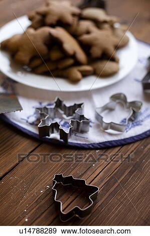 Cookie cutters by plate of Christmas cookies View Large Photo Image Stock Photo - Cookie cutters by plate of Christmas cookies. Fotosearch