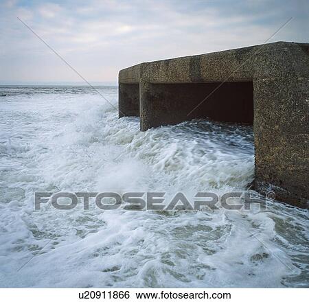 Stock Photograph - Cooling water outfall into sea from power station, UK.. Fotosearch