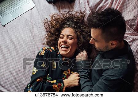 Couple bonding in bed View Large Photo Image Picture - Couple bonding in bed. Fotosearch