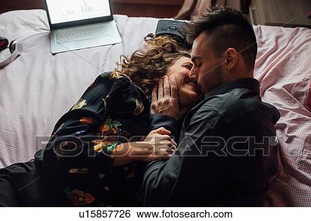 Couple bonding in bed View Large Photo Image Stock Photograph - Couple bonding in bed. Fotosearch
