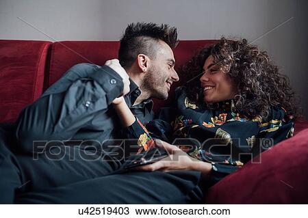 Stock Image - Couple bonding on sofa. Fotosearch