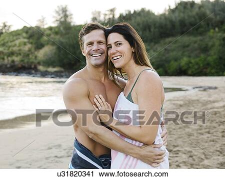 Couple embracing on beach View Large Photo Image Stock Image - Couple embracing on beach. Fotosearch