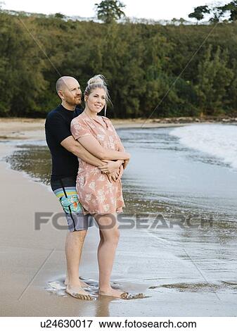 Couple embracing on beach View Large Photo Image Stock Photo - Couple embracing on beach. Fotosearch