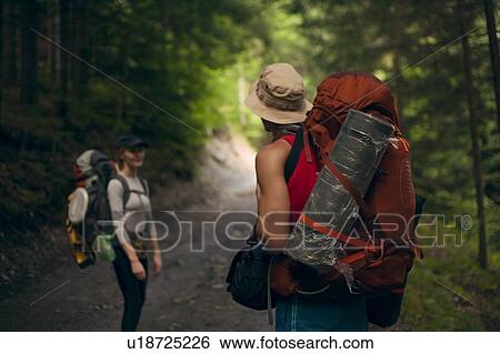 Stock Photograph - Couple hiking in forest at the Carpathian Mountain Range, Ukraine. Fotosearch