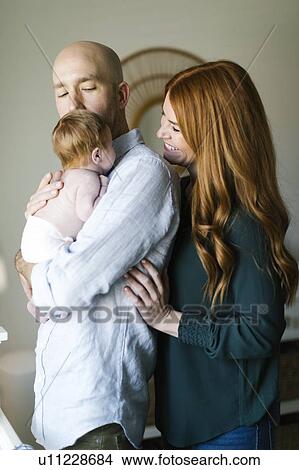 Picture - Couple holding their newborn son. Fotosearch