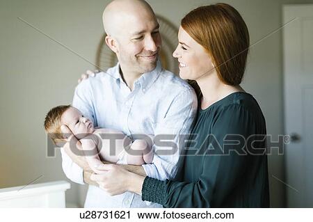 Couple holding their newborn son View Large Photo Image Stock Image - Couple holding their newborn son. Fotosearch