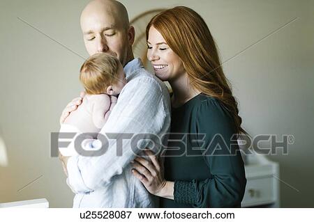 Couple holding their newborn son View Large Photo Image Stock Photo - Couple holding their newborn son. Fotosearch