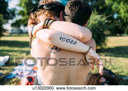 Stock Image - Couple hugging in park. Fotosearch