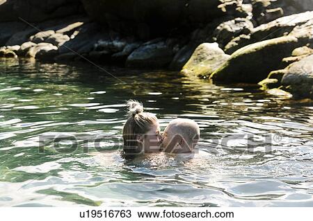 Couple kiss while swimming in sea View Large Photo Image Stock Image - Couple kiss while swimming in sea. Fotosearch