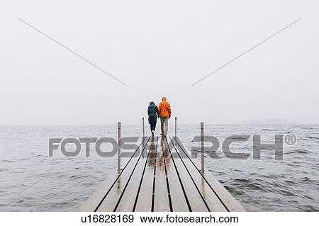 Couple on pier in Iceland View Large Photo Image Stock Photo - Couple on pier in Iceland. Fotosearch