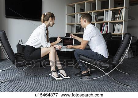Coworkers having meeting in office View Large Photo Image Stock Photo - Coworkers having meeting in office. Fotosearch
