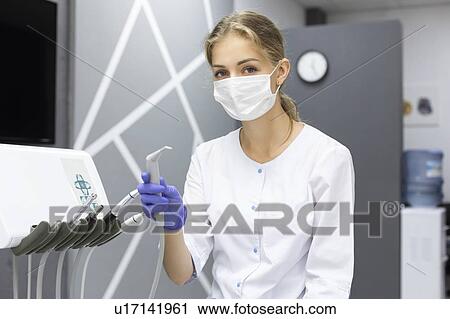 Dental assistant holding dental equipment View Large Photo Image Stock Image - Dental assistant holding dental equipment. Fotosearch