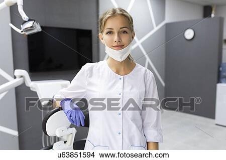 Picture - Dental assistant in dentist's surgery. Fotosearch