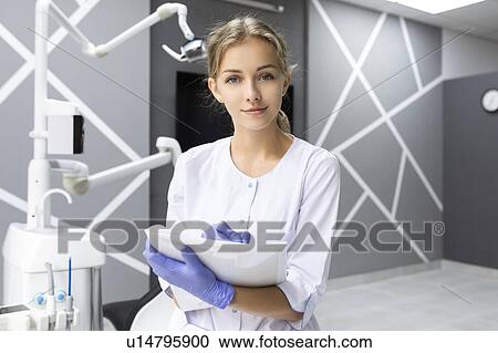 Dental assistant writing notes View Large Photo Image Stock Image - Dental assistant writing notes. Fotosearch