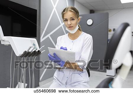 Dental assistant writing notes View Large Photo Image Stock Photo - Dental assistant writing notes. Fotosearch