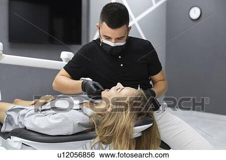 Stock Photograph - Dentist examining patient. Fotosearch