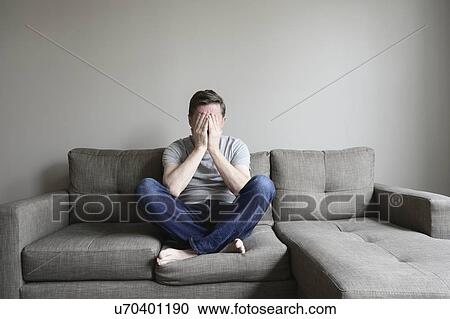Depressed mature man sitting on couch View Large Photo Image Stock Image - Depressed mature man sitting on couch. Fotosearch