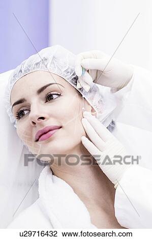 Dermatologist applying thread applicator on woman's face, close-up. View Large Photo Image Stock Image - Dermatologist applying thread applicator on woman's face, close-up.. Fotosearch