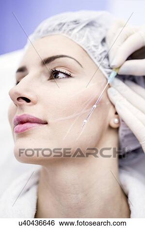 Dermatologist drawing marks on woman face for thread-lift, close-up. View Large Photo Image Stock Photograph - Dermatologist drawing marks on woman face for thread-lift, close-up.. Fotosearch
