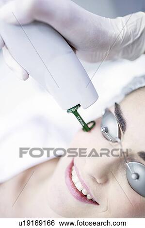 Dermatologist using laser machine on woman's face, close-up. View Large Photo Image Stock Photograph - Dermatologist using laser machine on woman's face, close-up.. Fotosearch