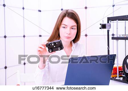 Picture - Designer working with 3D printer.. Fotosearch