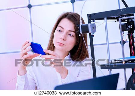 Stock Image - Designer working with 3D printer.. Fotosearch