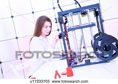 Stock Image - Designer working with 3D printer.. Fotosearch