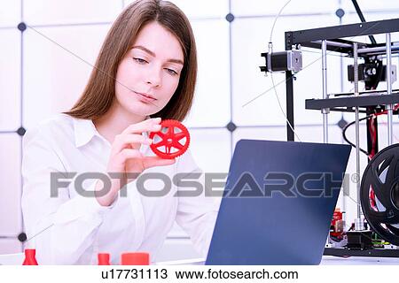 Stock Image - Designer working with 3D printer.. Fotosearch