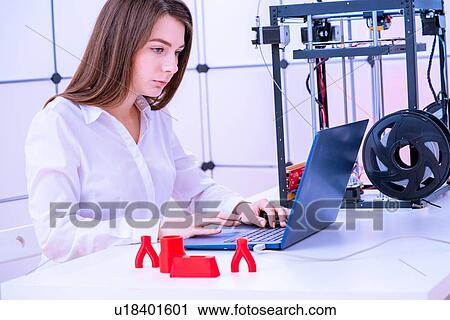 Stock Image - Designer working with 3D printer.. Fotosearch