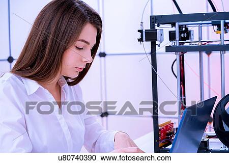 Stock Image - Designer working with 3D printer.. Fotosearch