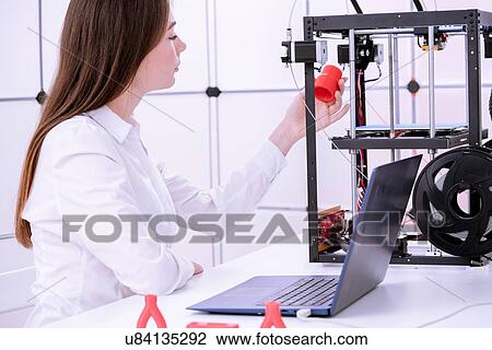 Stock Image - Designer working with 3D printer.. Fotosearch