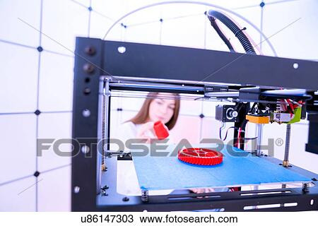Stock Image - Designer working with 3D printer.. Fotosearch