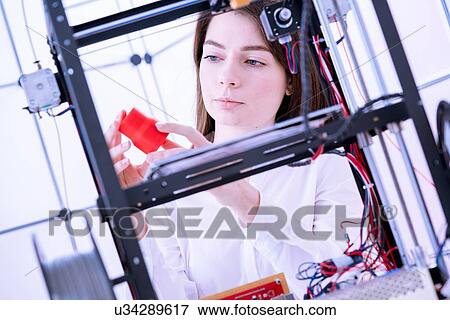 Stock Photo - Designer working with 3D printer.. Fotosearch