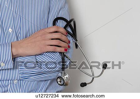 Picture - Doctor holding stethoscope. Fotosearch