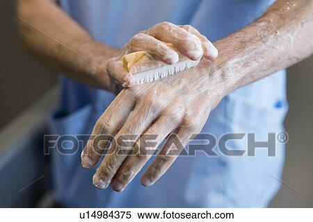 Doctor scrubbing hands with brush in hospital. View Large Photo Image Stock Photography - Doctor scrubbing hands with brush in hospital.. Fotosearch